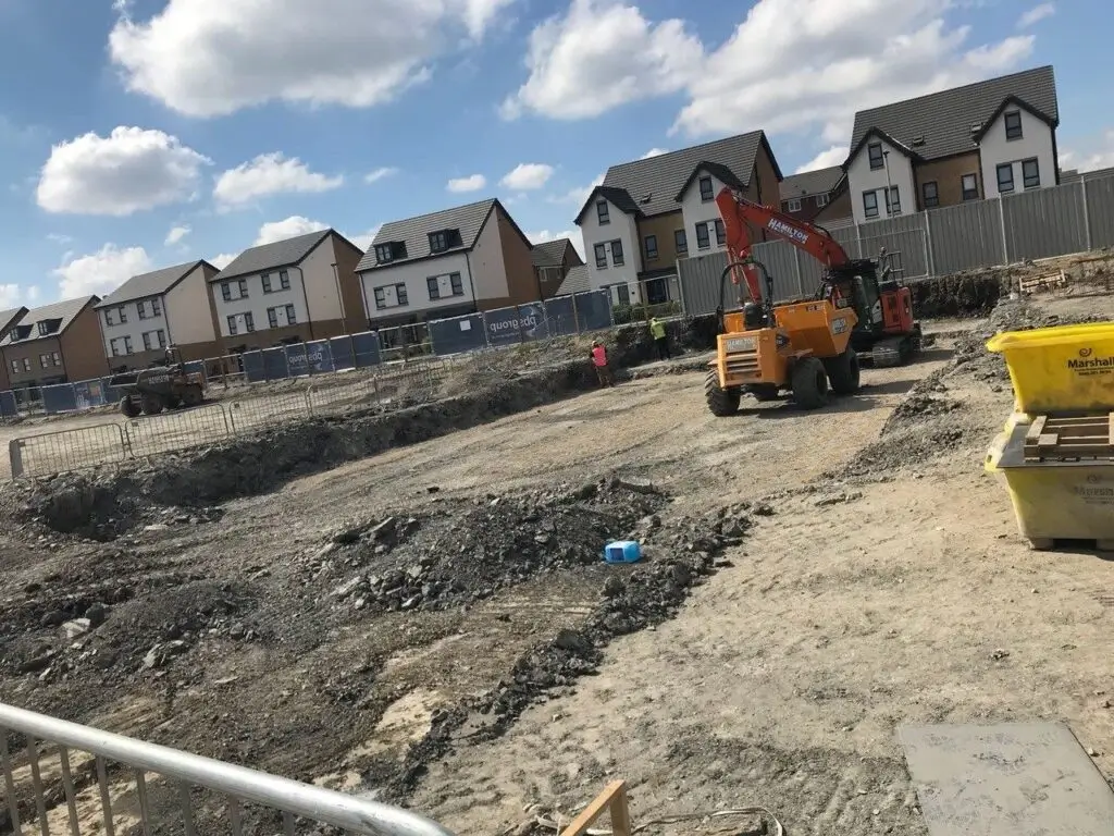 A construction site with heavy machinery preparing land for a new housing development, showcasing Earthworks Hawkes Bay’s land-clearing services.