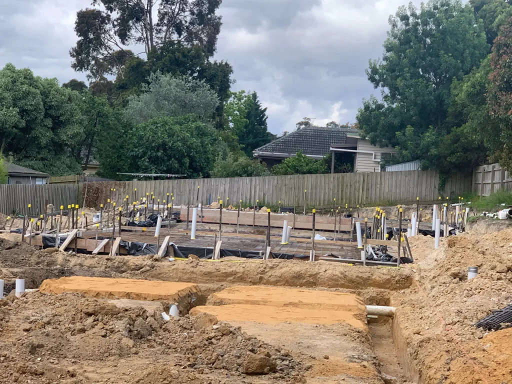 A construction site with trenches and foundation preparations, illustrating Earthworks Hawkes Bay’s site preparation process.