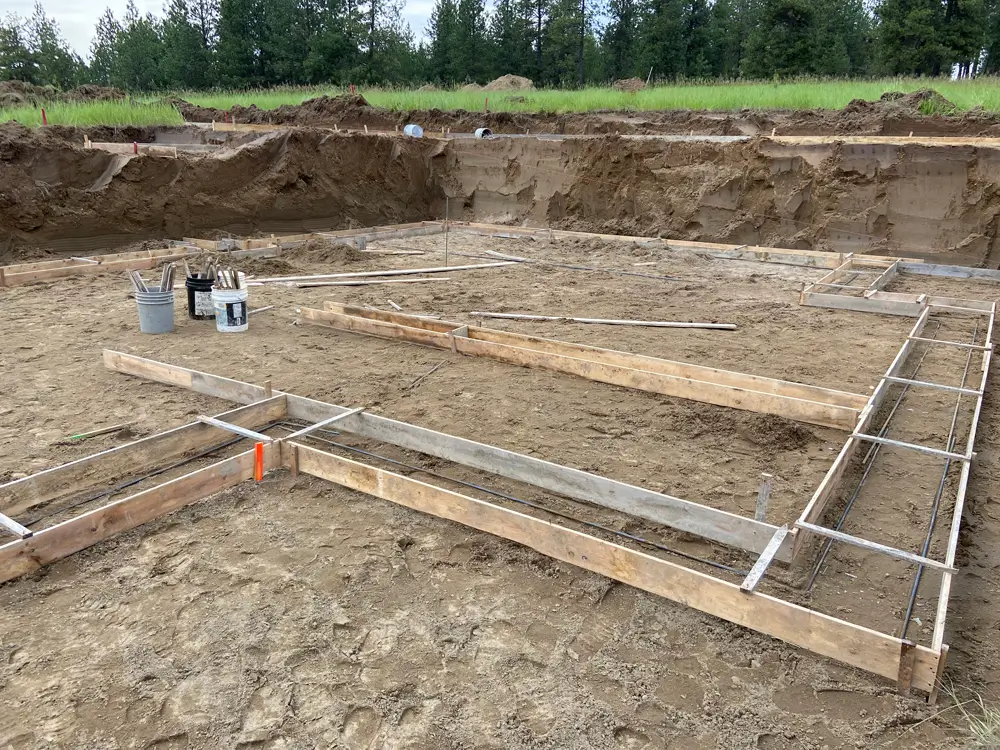 A construction site with wooden framework for a foundation, representing Earthworks Hawkes Bay's meticulous site preparation process.
