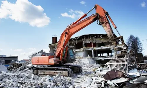 A yellow excavator tearing down an old house, highlighting Earthworks Hawkes Bay’s precision in Demolition Work. A yellow excavator tearing down an old house, highlighting Earthworks Hawkes Bay's precision in Demolition Work.